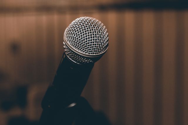 Home A focused shot of a microphone with a blurred background, capturing elegance and simplicity.